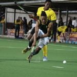 Alfred Ntiamoah tackles his opponent from behind during their match against South Africa
